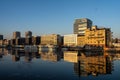 Row of buildings reflected on water on a sunny day