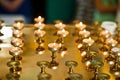 Row of burning circle candles on a golden stand at church Royalty Free Stock Photo