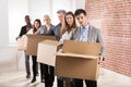 Row Of Businesspeople Standing With Cardboard Boxes Royalty Free Stock Photo