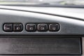 A row of buttons for controlling the light and heating the rear window in black with white symbols of an old Russian car on a gray Royalty Free Stock Photo