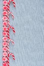 Row of candy canes and peppermint swirl candies flat lay border