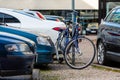 A row of cars and bicycle in the parking lot near the office building Royalty Free Stock Photo
