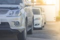 Row of cars parked on concrete floor at car parking lot with sunlight background. Royalty Free Stock Photo