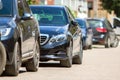 Row of cars parked near curb on the side of the street on a parking lot Royalty Free Stock Photo