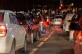 row of cars stopped in front of traffic light at night Royalty Free Stock Photo