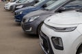 Row of cars on summer day parking - close-up view on front parts from side Royalty Free Stock Photo