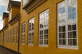 Row of casement windows on yellow house