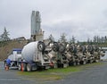 Row of cement mixer trucks