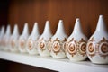 row of ceramic bells on a shelf