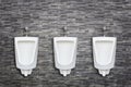 Row of ceramic outdoor urinals in men public toilet install on t