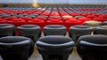 row of chairs are empty in a stadium. The chairs are black and red Royalty Free Stock Photo