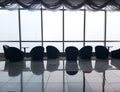 Row of chairs in executive office waiting room. background outdoor modern lobby big window and blue sky with clouds. Royalty Free Stock Photo