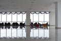 Row of chairs in executive office waiting room. background outdoor modern lobby big window and blue sky with clouds. Royalty Free Stock Photo