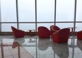 Row of chairs in executive office waiting room. background outdoor modern lobby big window and blue sky with clouds. Royalty Free Stock Photo