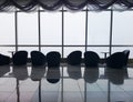 Row of chairs in executive office waiting room. background outdoor modern lobby big window and blue sky with clouds. Royalty Free Stock Photo