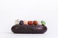 Row Of Chakra Crystals on hot massage black stones