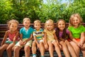 Row of children on the bench in park Royalty Free Stock Photo