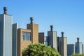 Row of chimneys with visible windows and front yard trees with blue and white sky in the historic districts of san Royalty Free Stock Photo