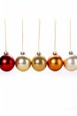 Row of christmas ornaments hanging from strings on white background. Generative AI Royalty Free Stock Photo