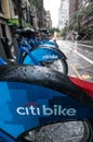 A row of Citibikes on a New York City street on a rainy day. Royalty Free Stock Photo