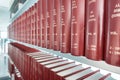 Row of classic books in modern bookshelf Royalty Free Stock Photo