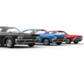 Row of classic muscle cars - black, blue and red Royalty Free Stock Photo