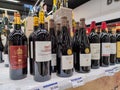 Row of Classified Growths bottles French wines display for sell in the supermarket shelves