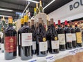 Row of Classified Growths bottles French wines display for sell in the supermarket shelves