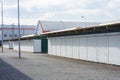 A row of closed market stalls with white shutters with blue sky Royalty Free Stock Photo