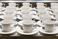 Row of coffee and tea ceramic white cup preparing to serve on the business conference in front of the meeting room at the hotel