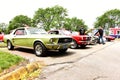 Row of collector cars Green and Red Mustangs