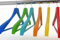 Row of color coat hangers on metal clothes rail Royalty Free Stock Photo