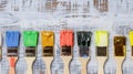 A row of colored paintbrushes on an abstract background creates a vibrant scene, Ai Generated Royalty Free Stock Photo