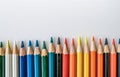 Row of Colored Pencils Against White Background Royalty Free Stock Photo