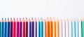 A row of colored pencils arranged in a rainbow gradient on a white background. This image shows a line of colored Royalty Free Stock Photo