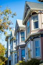 Row of colorful apartment buildings or town homes with gable style roofs and fancy windows in San Francisco California Royalty Free Stock Photo