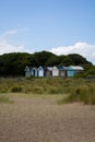 Row of colorful beach huts on a sandy beach Royalty Free Stock Photo