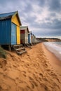 a row of colorful beach huts on a sandy shore Royalty Free Stock Photo