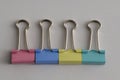 A row of colorful binder clips