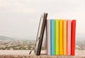 Row of colorful books with electronic book reader Royalty Free Stock Photo