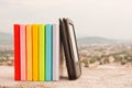 Row of colorful books with electronic book reader Royalty Free Stock Photo