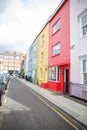 Row of colorful British houses with handrails and plants