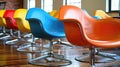 A row of colorful chairs are arranged in a room Royalty Free Stock Photo