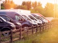 Row of colorful commercial vans in a dealership for sale or rent. Used and new busses. Transport industry. Selection of cargo