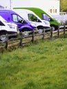 Row of colorful commercial vans in a dealership for sale or rent. Used and new busses. Transport industry. Selection of cargo