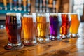 Row of colorful craft beer glasses on a bar