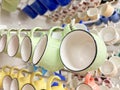 A row of colorful cups hanging on a rack