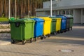 A row of colorful dustbins