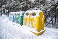 A row of colorful dustbins for waste segregation .