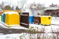 A row of colorful dustbins for waste segregation